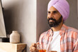 © Wavebreak Media - Holding cup of tea, man in turban relaxing at home, copy space