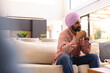 © Wavebreak Media - Sitting on couch, man in turban thinking deeply in modern living room, copy space