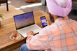 © Wavebreak Media - Booking travel online, man using laptop and smartphone at home with tea