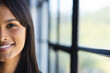 © Wavebreak Media - Smiling woman in office, close-up portrait with natural light through window, copy space
