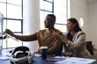 © Wavebreak Media - Collaborating in office, colleagues pointing at computer screen discussing project