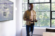 © Wavebreak Media - Presenting business ideas, man holding tablet and standing in modern office, copy space