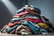 © Introvertia - Large pile of folded and colorful rumpled fabrics of various colors and textures on minimalist background