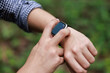 © SHUTTER DIN - Close up, man using smart watch, setting up his smart watch in the forest, goal achievement, sport and fitness concept outdoors in nature..