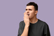 © Pixel-Shot - Handsome young man feeling bad smell from mouth on purple background