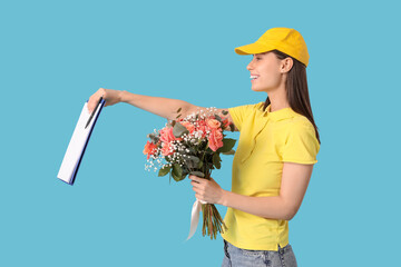 Poster - Young delivery woman with bouquet of beautiful flowers and clipboard on blue background