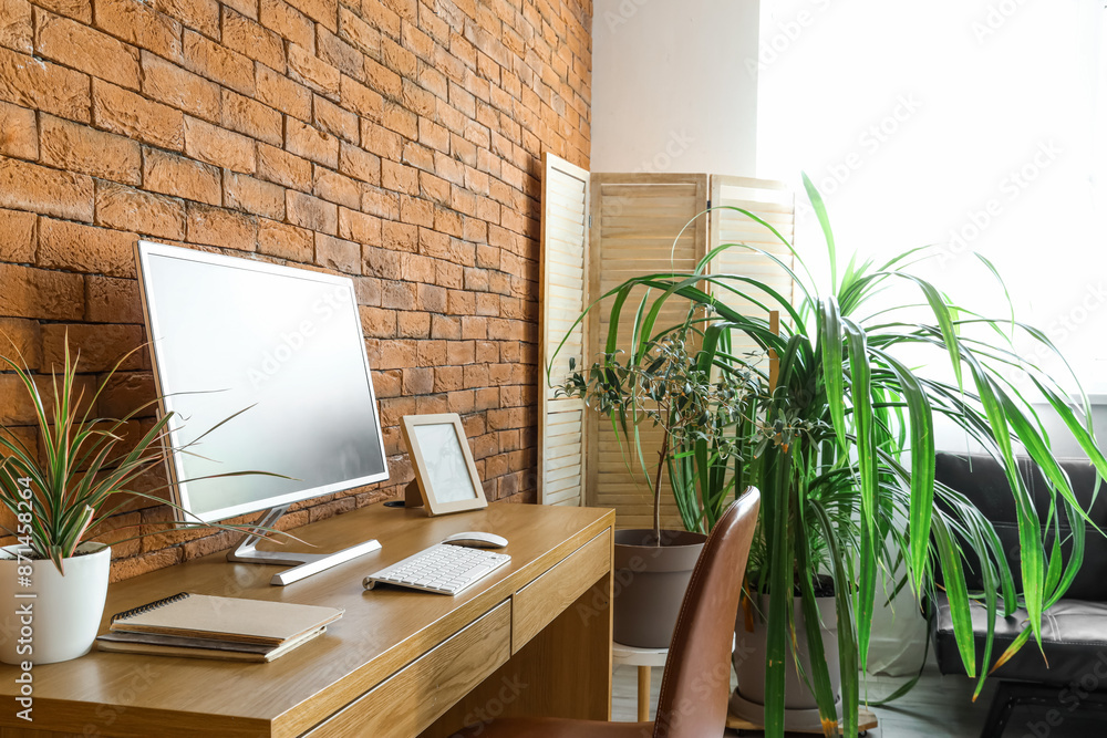 Interior of office with modern workplace and green houseplants