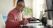 © CoetzeeRising/peopleimages.com - Senior man, laptop and writing at home for budget, planning and savings account for personal debt. Elderly person, computer and notebook in living room for finance, tax or loan payment on banking app