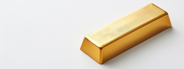  A gold object, closely captured against a pristine white backdrop, displays a gentle light reflection atop its surface