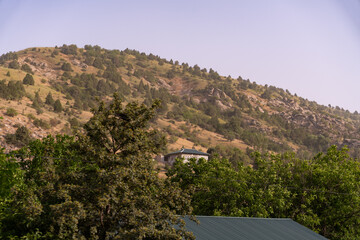 Wall Mural - A mountain with a house on top of it