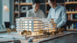 © retrostudio - Real estate developer and businessmen team working on new modern business park project in office. complex buildings scale model
