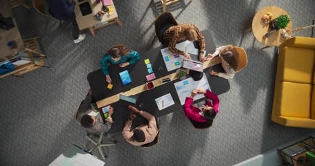 Poster - Top Down View: Innovative Teamwork at Office Table. Diverse Professionals Collaborate Using Laptops and Tablets, Strategizing and Brainstorming Ideas For Creative Business Problem Solving