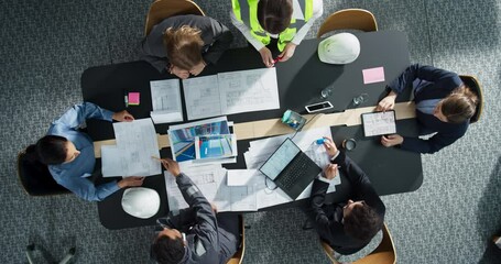 Aufkleber - Top Down View of Diverse Team of Business Professionals and Engineers Working Together on Architectural Plans in a Corporate Office. Focused Colleagues Using Laptop, Tablet, Blueprints And Documents.