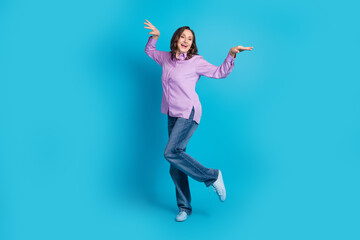 Poster - Full length photo of charming positive woman wear violet shirt dancing empty space isolated blue color background