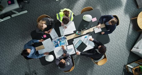 Aufkleber - Top Down View of Diverse Team of Real Estate Construction Engineers Working With Blueprints and Documents in an Office. Workspace Of Housing Development Company With Business MAnagers And Architects