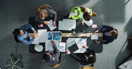 Aufkleber - Top Down View of Diverse Team of Business Professionals and Engineers Working Together on Architectural Plans in a Modern Office. Focused Colleagues Using Laptop, Tablet, Blueprints And Documents.
