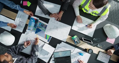Aufkleber - Top Down View of Diverse Team of Business Professionals and Construction Engineers Discussing Blueprints and Architectural Plans For Real Estate Projects in a Corporate Office. Using Laptop And Tablet