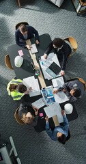 Aufkleber - Vertical Screen: Top Down View of Diverse Team of Real Estate Construction Engineers Working With Blueprints in an Office. Workspace Of Housing Development Company With Managers And Architects