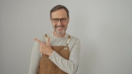 Sticker - Cheerful middle-aged man, apron-clad, points upwards, grinning from ear to ear, isolated on a pristine white background!