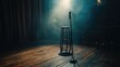 © Ellionn - Microphone and stool on empty stand up comedy stage before start of performance. Music concert, show or interesting speech at club. Karaoke bar. Fun comedian night.