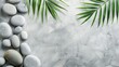 © pngking - Spa setting with white stone backdrop palm leaves and serene grey stones aerial view blank space
