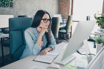 Wall Mural - Photo of attractive young woman minded work computer dressed denim clothes executive business leader work comfort beautiful office interior