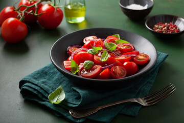 Wall Mural - healthy tomato salad with onion basil olive oil and balsamic vinegar