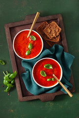 Wall Mural - tomato and bell pepper vegetarian soup on green background