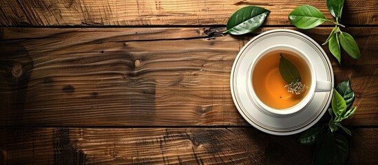 Sticker - Wooden table hosts a cup of fragrant green tea with ample copy space image.