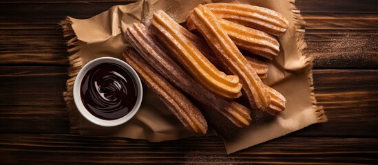Poster - Top view of churros drizzled with chocolate sauce and sugar on a rustic wooden surface, with space for additional images.