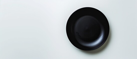 Aufkleber - Black plate on a white backdrop with copy space image.