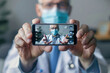© Neha - Doctor appearing virtually on a smartphone, welcoming with open hands