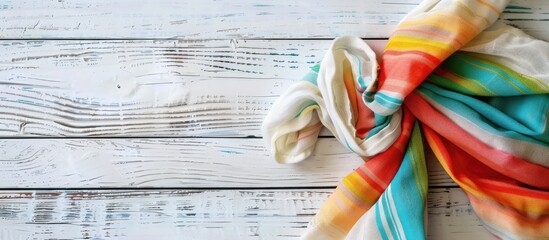 Aufkleber - A colorful fabric napkin lies on a white wooden surface, creating a lovely backdrop for any 'copy space image'.