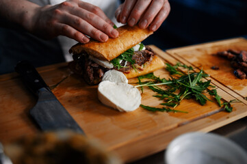 Chef preparing a beef sandwich