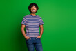 © deagreez - Photo portrait of young indian student funny guy with wavy hair wear striped t shirt and jeans isolated on green color background