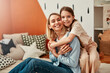 © Valerii Apetroaiei - A mother and daughter are sharing a loving moment together at home, smiling at each other