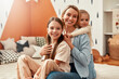 © Valerii Apetroaiei - Happy Family Moment Mother and Two Daughters Enjoying Quality Time Together at Home