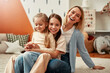 © Valerii Apetroaiei - Happy Family Moment Mother and Two Daughters Enjoying Quality Time Together at Home