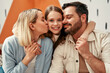 © Valerii Apetroaiei - Happy family with parents and daughter in a modern living room, radiating affection and happiness