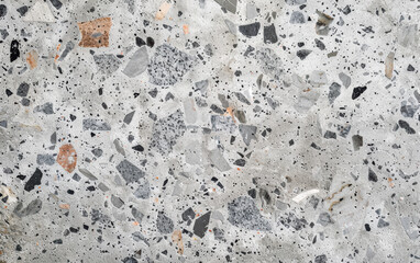 High-resolution texture of polished terrazzo stone with a mix of gray, white, and beige marble chips. Ideal for backgrounds, designs, and architectural projects.