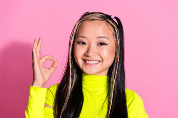 Wall Mural - Photo of good mood satisfied girl with dyed hairstyle dressed yellow turtleneck showing okey nice job isolated on pink color background