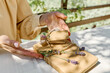 © Caterina Trimarchi - Woman making hand made gift package with craft recycled paper and dried lavender flowers on the table with linen tablecloth. Natural aesthetic.
