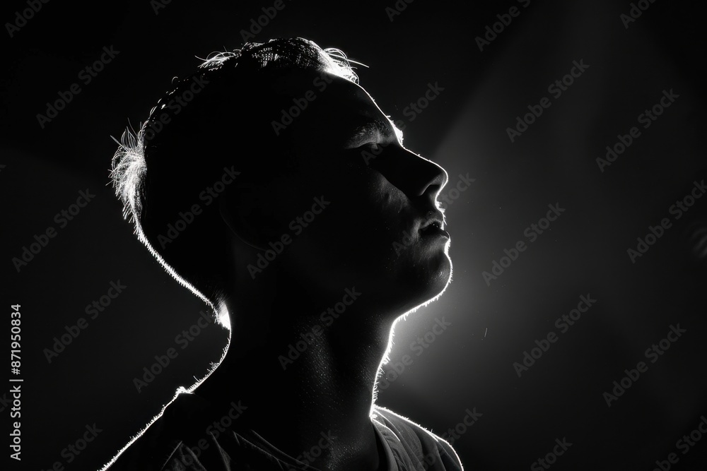 Silhouette of the head and shoulders against a black background, with ...