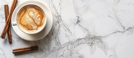 Aufkleber - Top view of a cup with coffee and cinnamon sticks on a marble surface providing copy space image.