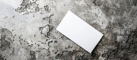 Canvas Print - Gray paper business card placed on a textured gray concrete background with space for text or design, shot from above in a minimalistic style.