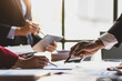 © Wasan - Business meeting, Company executives meeting discussing strategic analysis and business planning, group of people working with paperwork on a board room table at a business presentation or seminar.