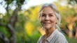 © esp2k - A woman with gray hair is smiling and looking at the camera