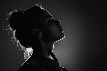 Wall Mural - Black and white photo of a woman's silhouette with a hand on her neck, low light, close-up shot, side view Generative AI