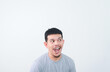 © IgnatiusHarly - Wow and shocked face of funny Asian man isolated on grey background.