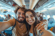 © Kakabe - Happy couple taking selfie inside airplane. Smiling man and woman enjoying their flight journey. Travel adventure and vacation concept.